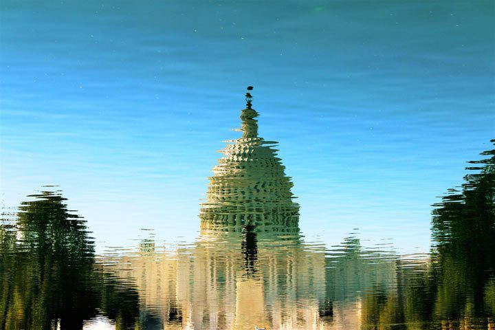 reflection of congress building in pond or lake