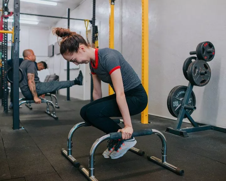 woman exercising at weight lifting gym - meth
