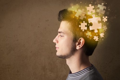 profile of man with puzzle pieces coming out of head