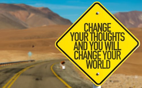 yellow road sign stating change your thoughts and you will change your world