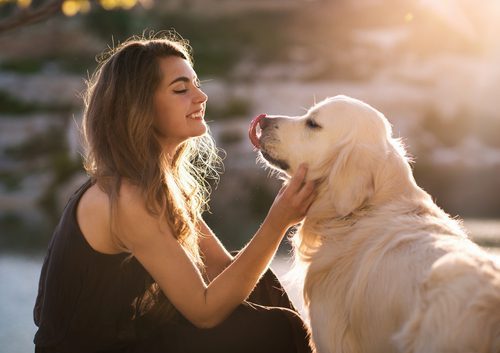 young woman petting dog