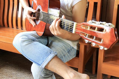 music therapy can be used for a number of mental health disorders as well as physical problems associated with trauma., man playing guitar