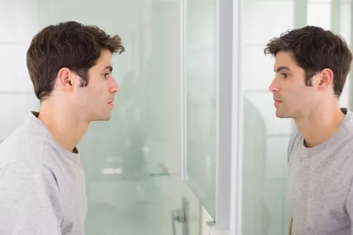 man looking into mirror