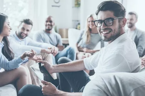 smiling man at group therapy meeting
