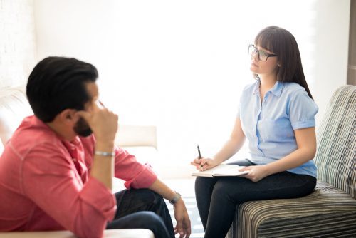 man at therapy with female counselor