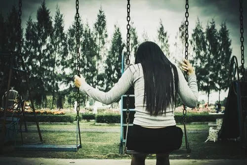 woman alone on swing set