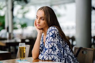 woman drinking beer at restaurant