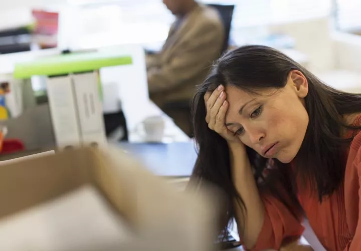 woman at office job looking stressed out - stress
