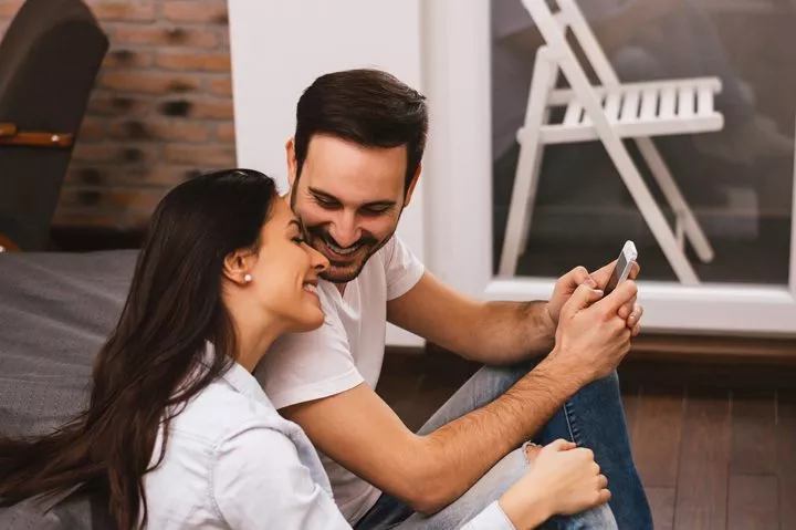 happy young hispanic couple talking at home - your relationships
