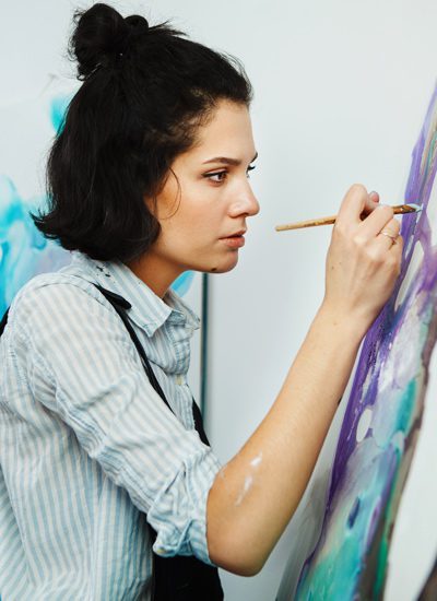 Experiential Therapy, pretty young brunette woman painting - art therapy - post-traumatic stress disorder