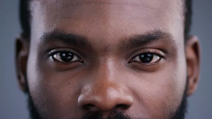 closeup of handsome Black man's face/eyes - BIPOC and mental health