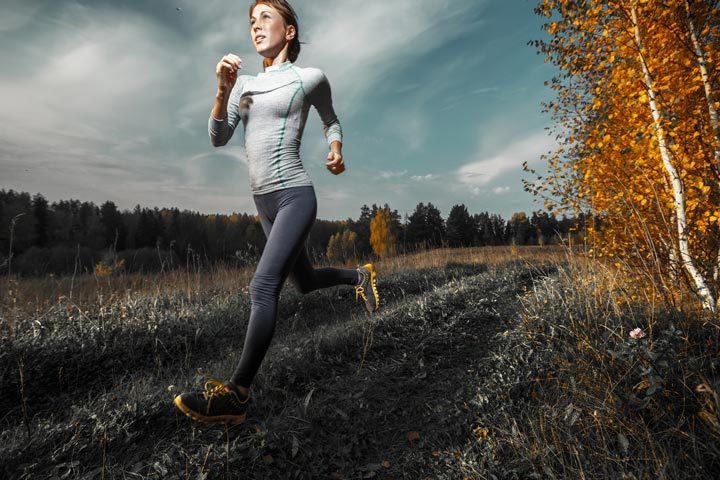 thin, athletic woman jogging outdoors during fall - bulimia nervosa