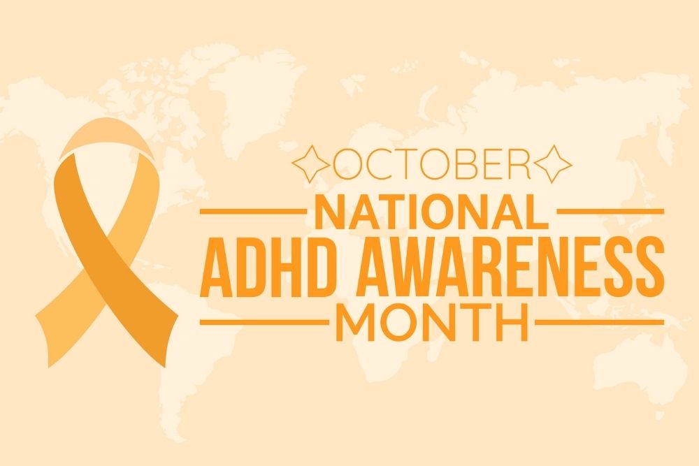 Graphic design for October National ADHD Awareness Month featuring an orange awareness ribbon and bold orange text on a light background.